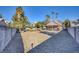 Backyard view showcasing gravel, trees, and a block wall at 1702 La Cruz Dr, Henderson, NV 89014