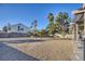 Spacious backyard with gravel, grass, and trees at 1702 La Cruz Dr, Henderson, NV 89014