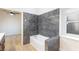 Bathroom with shower and tub, grey tile, and window at 1702 La Cruz Dr, Henderson, NV 89014