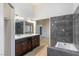 Bathroom with double vanity and grey tile shower at 1702 La Cruz Dr, Henderson, NV 89014