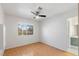 Bright bedroom featuring wood floors and ceiling fan at 1702 La Cruz Dr, Henderson, NV 89014