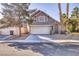 Two-story house with attached garage and landscaping at 1702 La Cruz Dr, Henderson, NV 89014