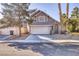 Two-story house with attached garage and desert landscaping at 1702 La Cruz Dr, Henderson, NV 89014