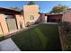 Spacious backyard with artificial turf and patio seating at 1806 Discus Dr, Las Vegas, NV 89108