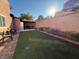 Landscaped backyard featuring a grassy area and patio at 1806 Discus Dr, Las Vegas, NV 89108