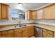 Bright kitchen featuring wood cabinets, granite countertops, and a stainless steel dishwasher at 210 Bristle Cone, Pahrump, NV 89048