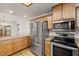 Well-equipped kitchen boasting stainless steel appliances, oak cabinets, and a neutral countertop at 210 Bristle Cone, Pahrump, NV 89048