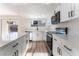 Bright kitchen featuring white cabinets, quartz countertops, and stainless steel appliances at 2113 La Harve Dr, Las Vegas, NV 89106