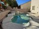 Inviting kidney-shaped pool with a built-in spa at 2273 Moresca Ave, Henderson, NV 89052