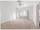 Spacious bedroom with plush carpet and sliding glass doors to balcony at 2536 Golden Sands Dr, Las Vegas, NV 89128