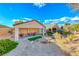 This backyard features a covered patio, perfect for outdoor dining and entertaining, with desert landscaping at 2571 Jada Dr, Henderson, NV 89044