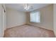 Neutral bedroom featuring a ceiling fan with light and a large window with blinds at 2571 Jada Dr, Henderson, NV 89044