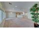 Open living room and kitchen with neutral colors and carpet at 2571 Jada Dr, Henderson, NV 89044