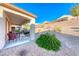 This covered patio offers a great spot for outdoor relaxation overlooking the desert landscaping at 2571 Jada Dr, Henderson, NV 89044