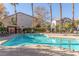 Community swimming pool with lounge chairs and shaded area at 2615 W Gary Ave # 1069, Las Vegas, NV 89123