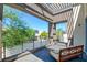 View from balcony showing bench seating, pergola roof, iron railing, and a neighborhood street view at 2680 Mystere Ct, Las Vegas, NV 89117