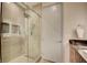 Bathroom featuring a glass shower, gray tile and floating vanity at 2680 Mystere Ct, Las Vegas, NV 89117