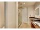 Bathroom featuring a glass enclosed shower, floating vanity, and sleek fixtures at 2680 Mystere Ct, Las Vegas, NV 89117