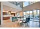 Open concept dining room adjacent to kitchen, featuring pool view through sliding glass doors at 2680 Mystere Ct, Las Vegas, NV 89117