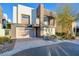 Modern two-story home with neutral color scheme, balcony, landscaped yard, and a two car garage at 2680 Mystere Ct, Las Vegas, NV 89117