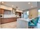 Modern kitchen featuring stainless steel appliances, marble countertop and stylish blue barstools at 2680 Mystere Ct, Las Vegas, NV 89117