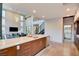 Modern kitchen with stainless steel appliances, marble countertop and open view to the living spaces at 2680 Mystere Ct, Las Vegas, NV 89117