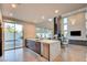 Open-concept kitchen with stainless steel appliances, marble countertop and connected living area at 2680 Mystere Ct, Las Vegas, NV 89117