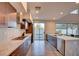 Bright kitchen featuring stainless steel appliances, marble countertop and sliding door access to outdoors at 2680 Mystere Ct, Las Vegas, NV 89117