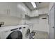 Clean laundry room with a washer, dryer, utility sink, ample cabinets and storage at 2680 Mystere Ct, Las Vegas, NV 89117