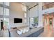 Contemporary living room featuring high ceilings, an oversized sectional sofa and a large wall mounted television at 2680 Mystere Ct, Las Vegas, NV 89117