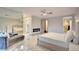 Bright main bedroom featuring an electric fireplace, ceiling fan, and a doorway to a custom walk-in closet at 2680 Mystere Ct, Las Vegas, NV 89117