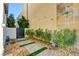 Landscaped side yard featuring a walkway, desert landscaping, and a gated entrance at 2680 Mystere Ct, Las Vegas, NV 89117