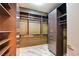 Custom closet features dark brown wood shelves and drawers for sophisticated storage and organization at 2680 Mystere Ct, Las Vegas, NV 89117