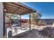 Backyard area featuring a covered patio, gravel, and desert landscaping with a mountain view at 2935 Kensington St, Las Vegas, NV 89156