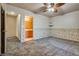 Bedroom showing gray carpet, ceiling fan, accent wall, shelves, and an attached bathroom at 2935 Kensington St, Las Vegas, NV 89156