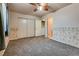 Bedroom featuring gray carpet, closet, ceiling fan, window and open door to another room at 2935 Kensington St, Las Vegas, NV 89156