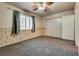 Bedroom featuring gray carpet, a window, ceiling fan, accent wall, and a closet at 2935 Kensington St, Las Vegas, NV 89156