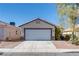 Charming single-story home with a two-car garage, desert landscaping, and neutral color palette at 2935 Kensington St, Las Vegas, NV 89156