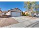 Inviting single-story home featuring a two-car garage, desert landscaping, and neutral color palette at 2935 Kensington St, Las Vegas, NV 89156