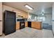 Open kitchen with black appliances and light wood cabinetry at 2935 Kensington St, Las Vegas, NV 89156