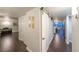 Bright hallway with dark hardwood floors and modern barn door at 3111 Bel Air Dr # 18F, Las Vegas, NV 89109