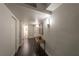 Hallway with dark hardwood floors and modern light fixtures at 3111 Bel Air Dr # 18F, Las Vegas, NV 89109