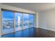 Living room with stunning city views and dark hardwood floors at 3111 Bel Air Dr # 18F, Las Vegas, NV 89109