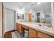 Elegant bathroom with double sinks, a large mirror, and wooden cabinets at 348 Wild Plum Ln, Las Vegas, NV 89107