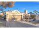 Front view of a single-story house featuring a garage and well-maintained landscaping at 348 Wild Plum Ln, Las Vegas, NV 89107