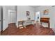 Bright hallway with hardwood floors, featuring decorative furniture and access to other rooms at 348 Wild Plum Ln, Las Vegas, NV 89107