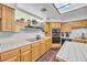 Bright kitchen with oak cabinets, tile counters, and modern appliances at 348 Wild Plum Ln, Las Vegas, NV 89107