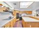 Kitchen with wood cabinets, tile countertops, and an island with seating at 348 Wild Plum Ln, Las Vegas, NV 89107