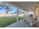 Covered patio with seating area, overlooking a grassy backyard at 348 Wild Plum Ln, Las Vegas, NV 89107