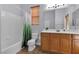 Clean bathroom with wood cabinets and a shower/tub combo at 3721 Alcantara Ln, North Las Vegas, NV 89084